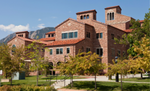 Image of the University of Colorado Boulder. A two story brick building. 