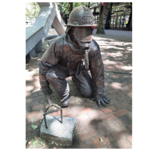 Image of the fire fighter memorial from the 1995 Seattle Warehouse fire. Shows one fire fighter bronze statue. 