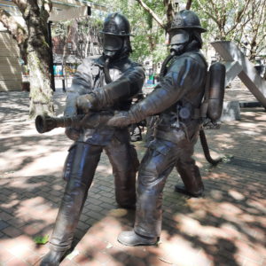 Image of the fire fighter memorial from the 1995 Seattle Warehouse fire. Shows two fire fighter bronze statues. 
