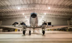 Image of an airplane in a hangar. NFPA 409 Standard on Aircraft Hangars.