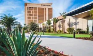 Exterior shot of the Durango Casino & Resort including landscaping and sidewalk in the front.